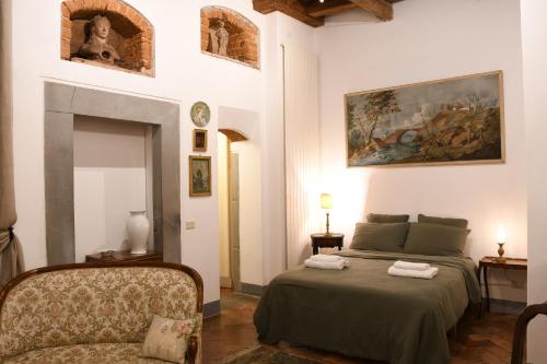 a bedroom with a bed and a chair in it at Casa Gori in Florence