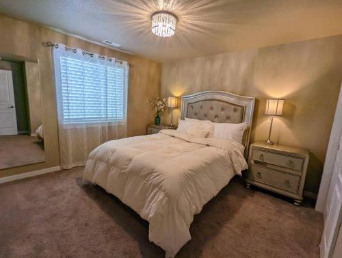 a bedroom with a large bed and a window at Spacious 3-bedroom home with outdoor space in Eugene