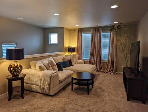 a living room with a couch and a table at Spacious 3-bedroom home with outdoor space in Eugene