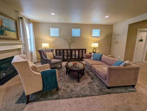 a living room with a couch and chairs and a fireplace at Spacious 3-bedroom home with outdoor space in Eugene