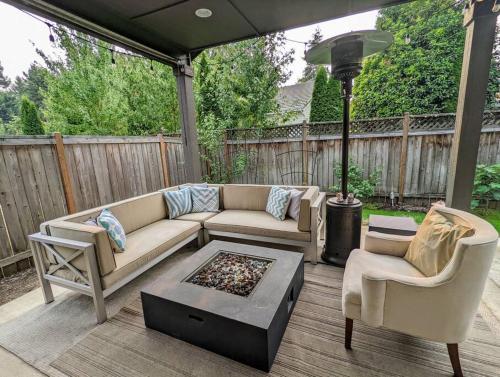 a patio with a couch and two chairs and a table at Spacious 3-bedroom home with outdoor space in Eugene