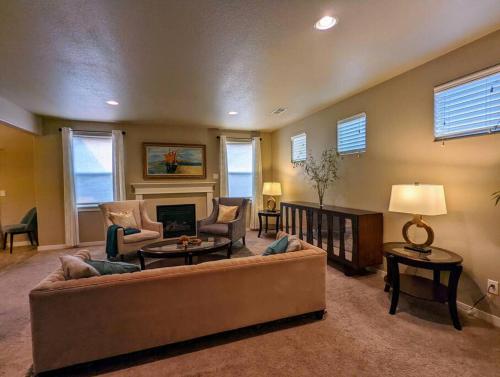 a living room with a couch and chairs and a fireplace at Spacious 3-bedroom home with outdoor space in Eugene