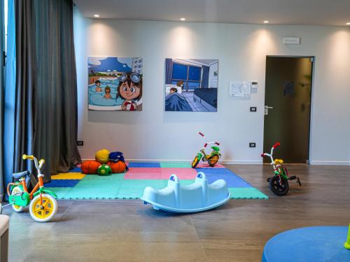 a childs room with toys on the floor at Nautilus Family Hotel in Pesaro