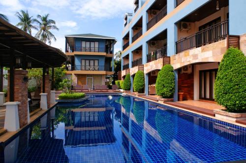 a swimming pool in front of a building at V Condominium Samui in Bophut 