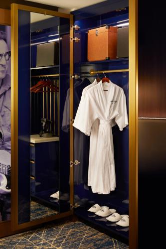 a wardrobe with a white shirt and shoes in it at Hard Rock Hotel New York in New York