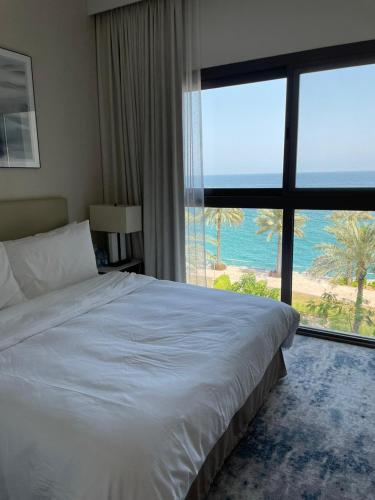 a bedroom with a bed with a view of the ocean at Sharm 3 Bedroom Luxury Apartment in Sharm
