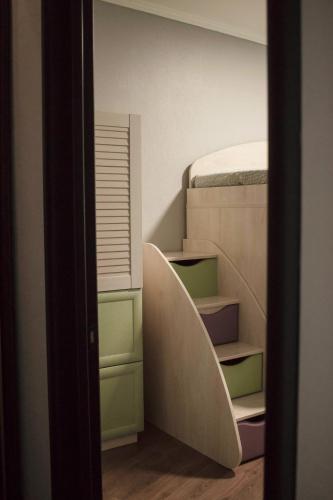 a room with a surfboard sticking out of a closet at Seven Apart Hotel in Vyshneve