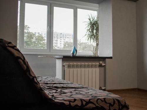 a living room with two windows and a radiator at Seven Apart Hotel in Vyshneve