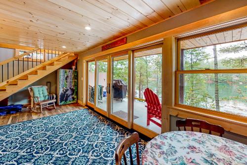 a room with a staircase and a table and chairs at Camp Two Loons in Oxford