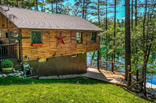 a log cabin with a star on the side of it at Camp Two Loons in Oxford