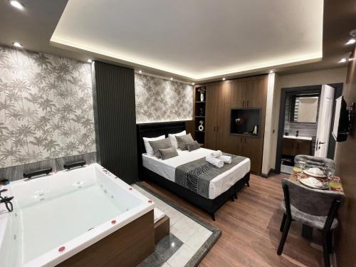 a bedroom with a tub and a bed and a bed and a bath tub at GRAND ÜSKÜDAR OTEL in Istanbul