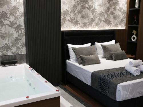 a bedroom with a bed and a bath tub at GRAND ÜSKÜDAR OTEL in Istanbul
