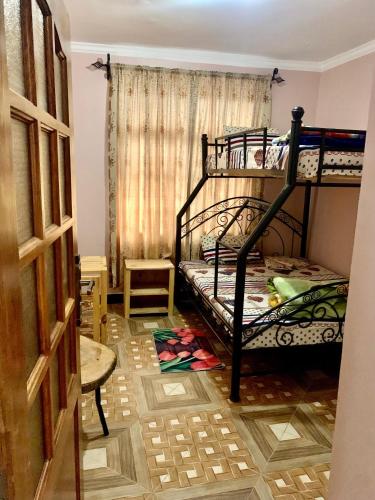 a bedroom with two bunk beds in a room at we are one apartment in Arusha