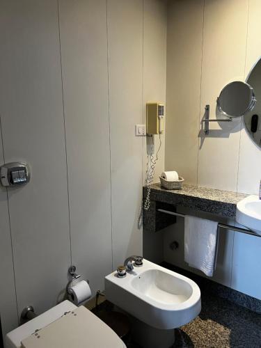 a bathroom with a white toilet and a sink at Hotel Bonaparte Flat Particular A in Brasilia