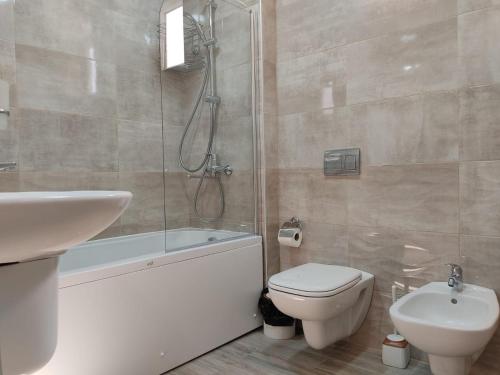 a bathroom with a shower and a toilet and a sink at Pushkin street Pearl in Kutaisi