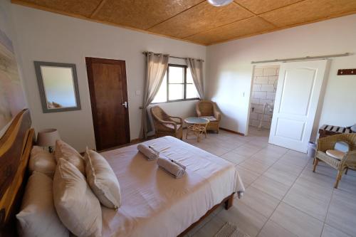 a bedroom with a bed and a living room at Duwisib Guest Farm in Duwisib