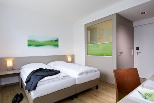 Un pat sau paturi într-o cameră la Good Rooms GmbH Guntramsdorf