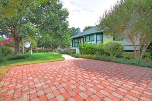 a brick driveway in front of a house at Granbury Gardens Bed and Breakfast in Granbury