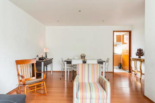a living room with a dining room table and chairs at At the heart of restaurants and night life in Mexico City