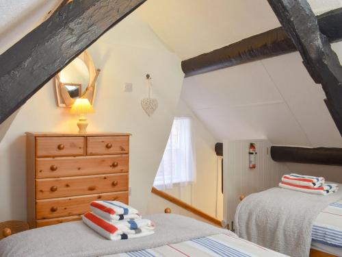 2 Betten in einem Schlafzimmer im Dachgeschoss mit einem Dach in der Unterkunft Cobblestones in Whitby