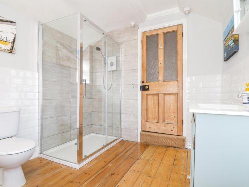 a bathroom with a shower and a toilet at Mackerel Sky in Penzance