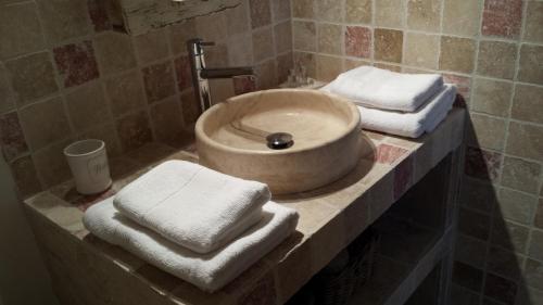 a bathroom with a sink with towels on a counter at Mas Saint Julien in Cavaillon