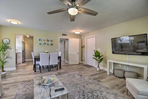 a living room with a ceiling fan and a table at 3 Blocks to the Coast! Cozy Sarasota Retreat in Sarasota