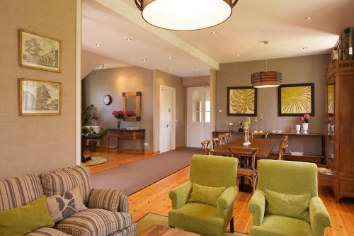 a living room with a table and a dining room at CASONA QUINTA HERMINIA in Gijón