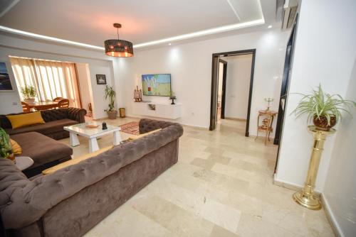 a living room with a couch and a table at Marina Agadir Family Sunny Holiday in Agadir