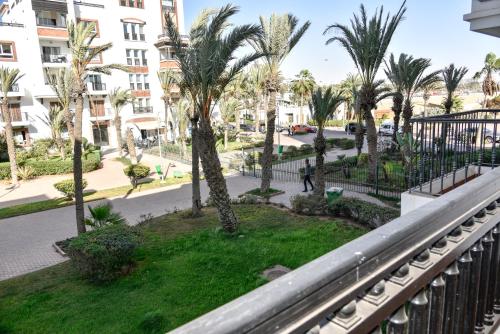 a balcony view of a street with palm trees at Marina Agadir Family Sunny Holiday in Agadir