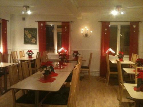 a restaurant with tables and chairs with christmas decorations at Målilla Hotell & Restaurang in Målilla