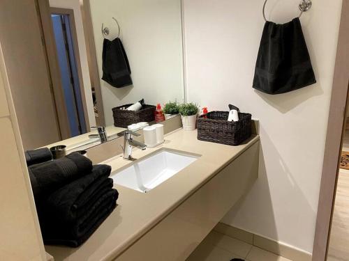 een badkamer met een wastafel en een spiegel bij Brand New 1 Bedroom, Vacation Home! in Abu Dhabi