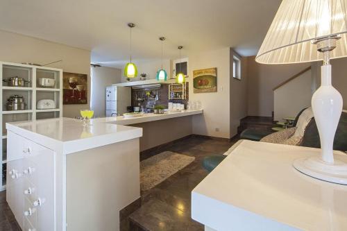 a kitchen with a counter and a table with a lamp at Villa Skalinada in Baška Voda