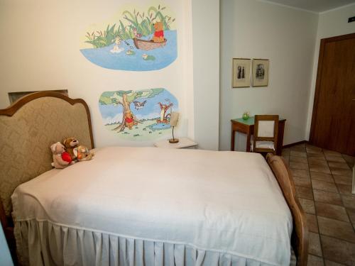a bedroom with a bed with a teddy bear on it at B&B del Gran Ducato di Alzano Sopra in Alzano Lombardo