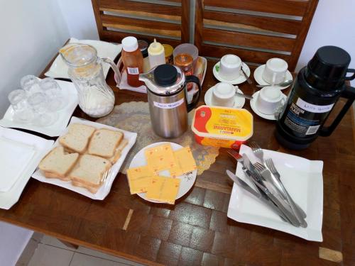 a table with bread and other items on it at RESIDENCIAL AFRICA,LDA-NAMPULA in Nampula