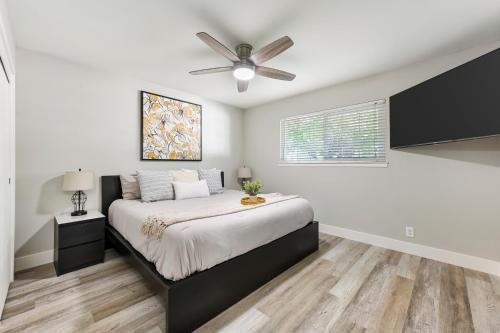 a bedroom with a bed and a ceiling fan at Fully Renovated 4 Bedroom Home with Pool! in Roseville