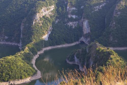 an aerial view of a river in a mountain valley at Vidikovac Uvac in Družiniće
