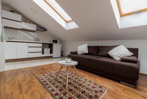 a living room with a couch and a table at Hill apartman - MAKSIMIR Rebro in Zagreb