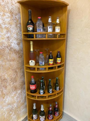 a shelf filled with lots of bottles of beer at RÉSIDENCE MARTHA in Yaoundé