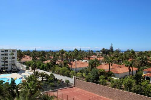 an aerial view of a resort with a pool and palm trees at Apartments ALOE TOP FLOOR in Playa del Ingles