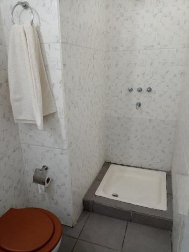 a bathroom with a shower with a toilet and a towel at Filipo Departamento in Paso de los Libres