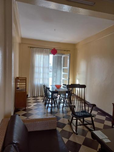 uma sala de estar com uma mesa e cadeiras e um sofá em Appartement sympathique Jules Ferry. em Dakar