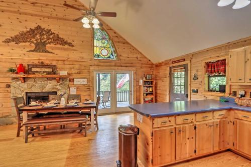 a kitchen with a table and a stone fireplace at Rivers Edge - Ultimate Riverfront Getaway in Hayesville