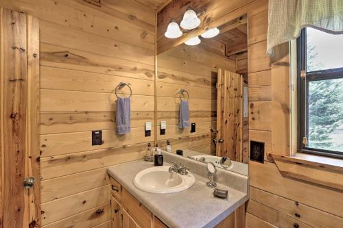 a bathroom with a sink and a mirror at Rivers Edge - Ultimate Riverfront Getaway in Hayesville