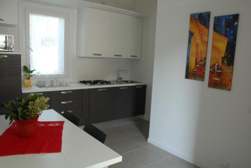 a kitchen with white cabinets and a white counter top at Da Irene in Mestre
