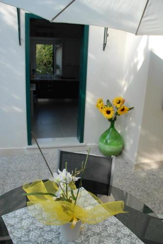 a table with a vase with flowers on it at Da Irene in Mestre