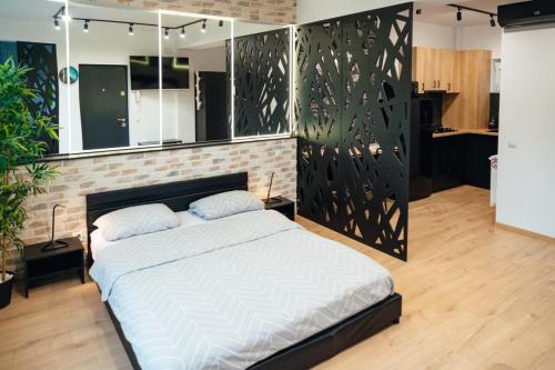 a bedroom with a bed and a brick wall at Belle View Apart Hotel in Turda
