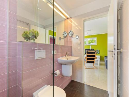 a bathroom with a sink and a glass shower at Beautiful Seaside Holiday Home in Zierow in Zierow