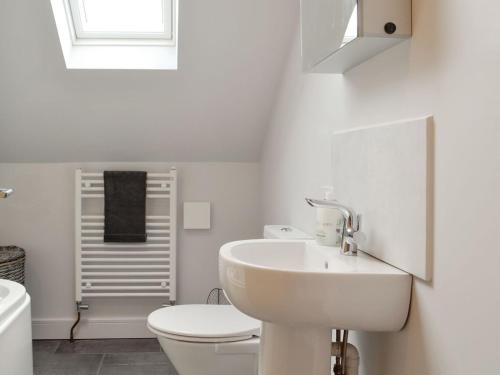 a white bathroom with a sink and a toilet at The Old Chapel in Grosmont