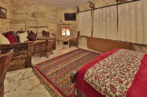 a bedroom with a bed and a room with a bed sqor at Old Town Stone House in Goreme